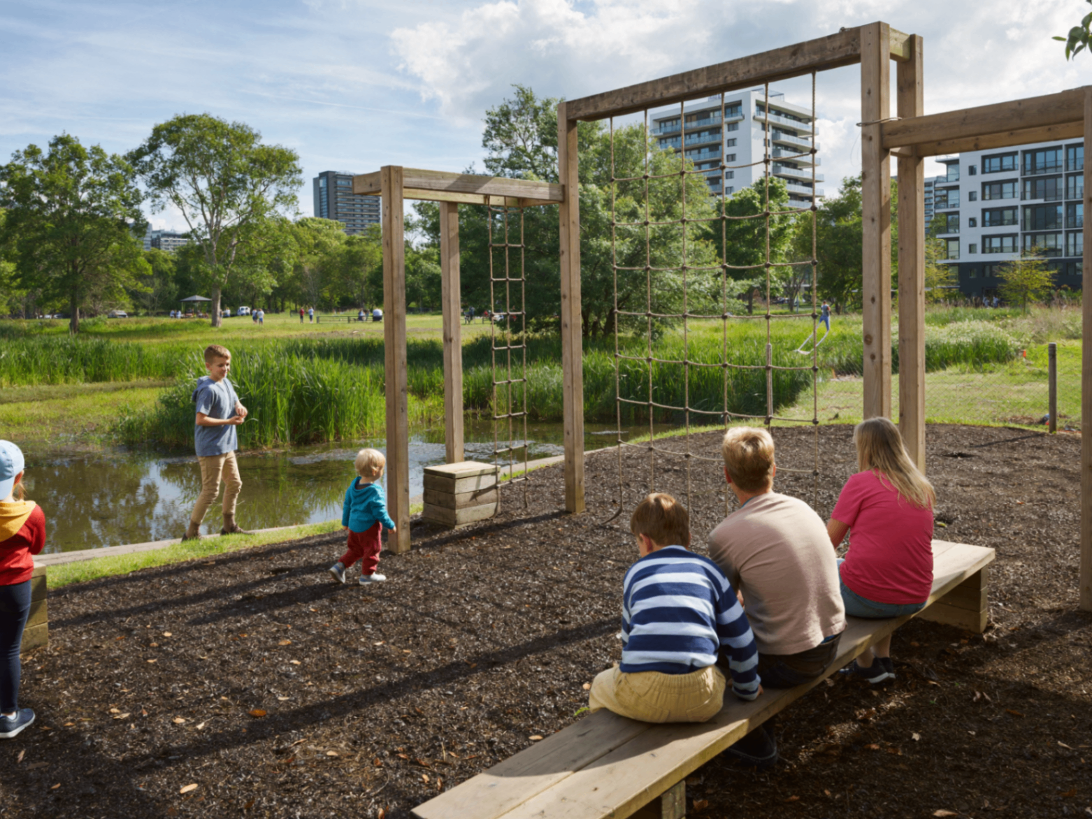 Kids playing by a wetland in a new masterplanned community park